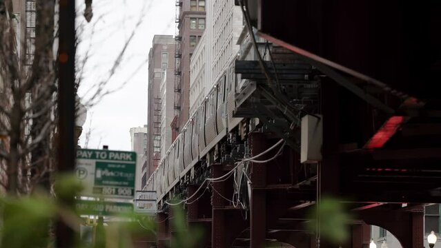 CTA Subway train passing on Elevated Track in the Loop of Chicago, seen from below on Street, Sidewalk Level