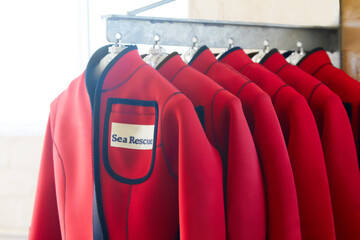 Always close at hand. Shot of wetsuits on a hanger.