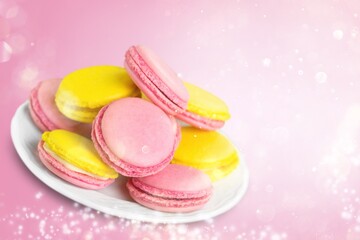 Plate with tasty macaroons on background. Sweet food concept