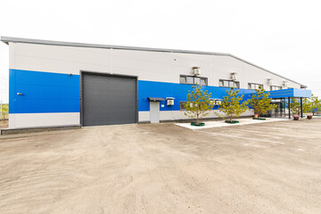 Facade of a factory building or warehouse outside including the front entrance and door of the loading and unloading terminal