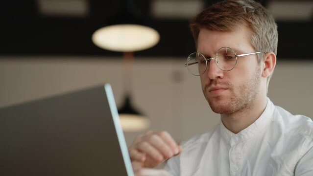 specialist of technical support of big IT company is reading questions and answering in online chat, portrait