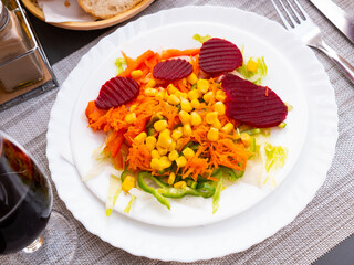 Image of a delicious light vegetable salad made from corn, chopped bell peppers, beets, onions and worn carrots