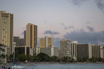 The sun sets on Honolulu, as seen from the lively beaches of Waikiki, a popular spot for sunbathing and surfing, as well as home to many luxury shops, high-rise resorts and restaurants