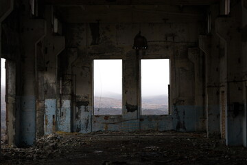 Destroyed houses and buildings. Nature pollution. Old abandoned huge coal pit. Ruins and stones. Ruins and huge mountains of dirty rock. Concrete industrial building. Dust and damaged house