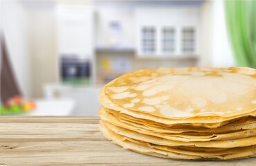 Stack of traditional Russian pancakes on wooden desk. Traditional Russian food.