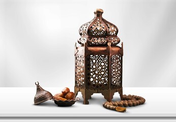 Ramadan Kareem and iftar Muslim holiday concept. Dried dates and lanterns with candles.