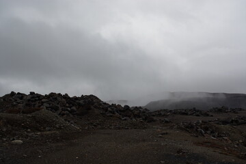 Old abandoned huge coal pit. Nature pollution. Ruins and stones. Ruins and huge mountains of dirty rock. 