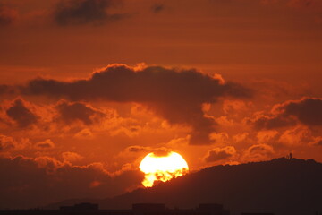 Bright sun rising through the mountain
