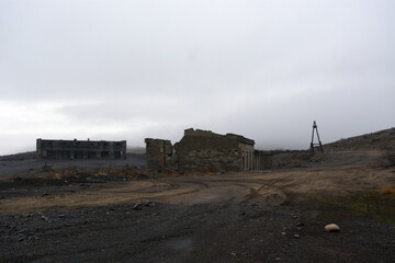 Destroyed houses and buildings. Nature pollution. Old abandoned huge coal pit. Ruins and stones....