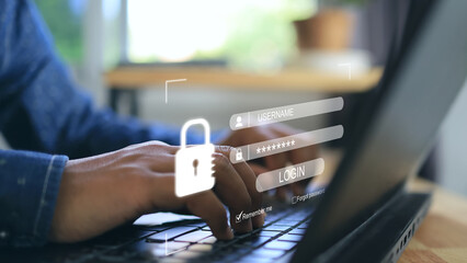 A man's hand presses a laptop keyboard and a screen appears to enter username and password to login...