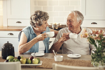 A good cup of coffee sets the tone for the day. Shot of a senior couple having breakfast together at home.