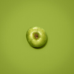 An apple a day. Shot of a green apple against an empty studio background.