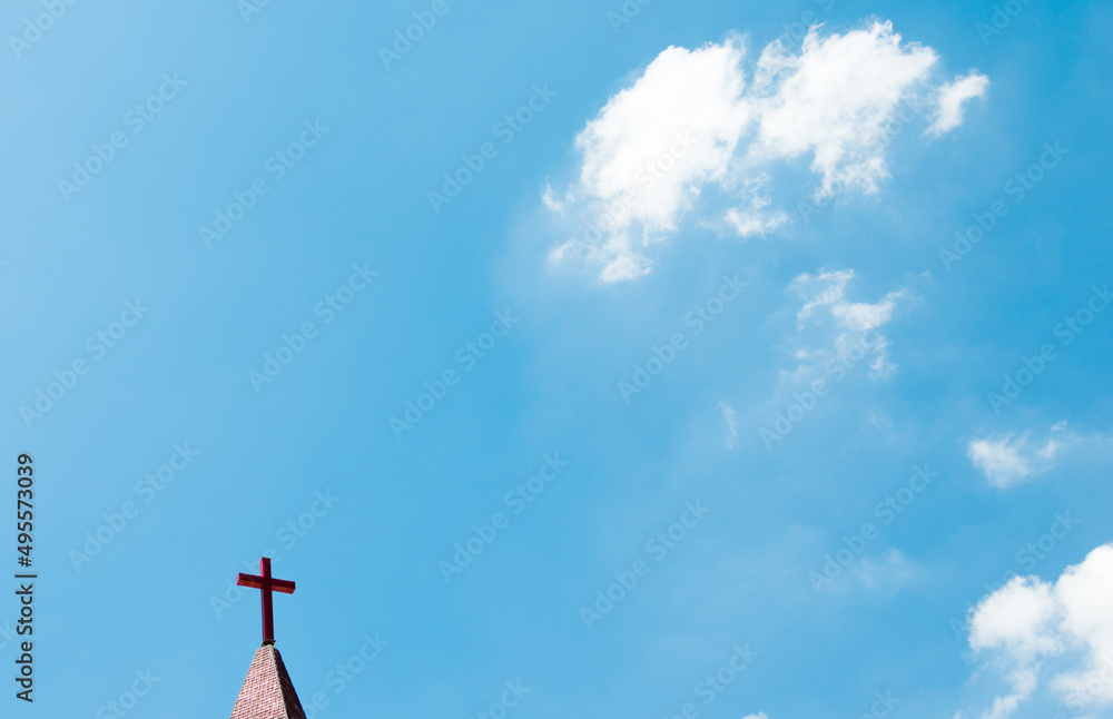Wall mural christian cross on the rooftop against blue sky - Wall murals