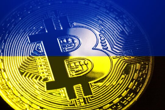 Physical version of Bitcoin and the color Ukrainian flag. Conceptual of Ukraine's cryptocurrency and blockchain technology.
