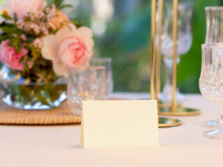 Naklejka na ściany i meble Mockup white blank space card, for Name place, Folded, greeting, invitation on wedding table setting background. with clipping path