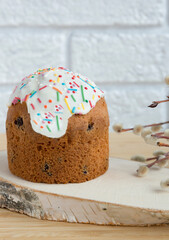 Easter cake on the table on a white background. The concept of the Easter holiday. Close-up. Selective focus. Vertical frame