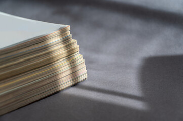 A stack of magazines against a gray background. Close-up of old print editions.