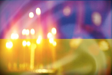 A burning candle the background of the national flag of Ukraine, yellow-blue, peace in Ukraine, no war
