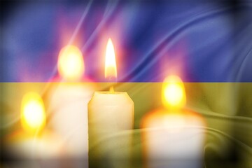 Obraz na płótnie Canvas A burning candle the background of the national flag of Ukraine, yellow-blue, peace in Ukraine, no war