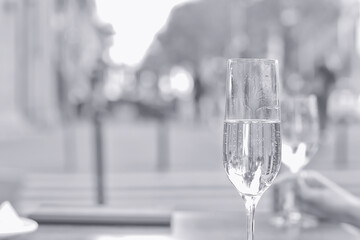 white wine glass in an outdoor cafe, spring view in a restaurant