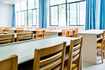 Empty classroom with chairs, desks and chalkboard