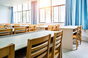 Empty classroom with chairs, desks and chalkboard