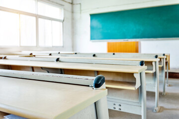 Empty classroom with chairs, desks and chalkboard