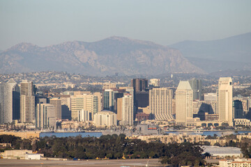Looking over the skyline of Downtown San Diego, Naval Air Station North Island  and the Peninsular Ranges in the distance from Point Loma