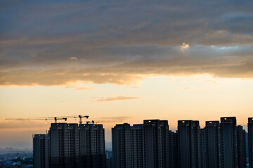 Construction of city buildings in the sunset