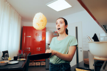 Funny Woman Flipping Pancakes in the Kitchen 