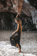 beautiful young woman at rocky background