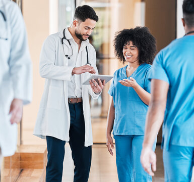 Digital Diagnosis Is Faster Diagnosis. Shot Of Two Young Doctors Using A Tablet And Having A Discussion In A Modern Office.