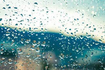 Rain drops on window glasses surface with sunset. drops on glass spray on window background for...