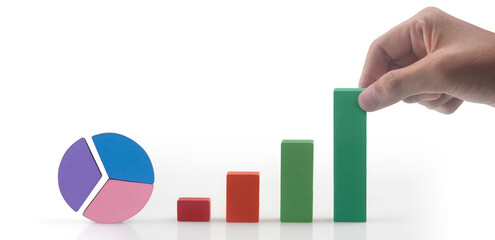 Business connecting piece of multi colored pie chart in  hand