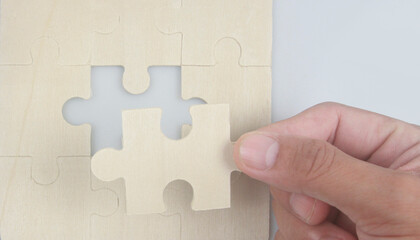 Connecting jigsaw puzzle in hand. Business solutions success and strategy concept