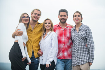 Fototapeta premium Company students best friends making selfies. Group young people posing together with thumb up. Multi ethnic business team. Smiling group of friends laughing.