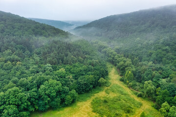 Aerial view drone shot of mountain tropical rainforest,Bird eye view image over the clouds Amazing nature background with clouds and mountain peaks