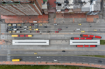 Aerial view of an avenue with vehicular traffic and a public bus station in the city of Bogota....