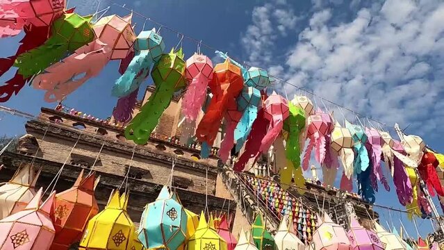 Thai lanna lantern colorful hang on rope with sunlight and light sky. Lantern made of paper, Lantern tradition handcraft.