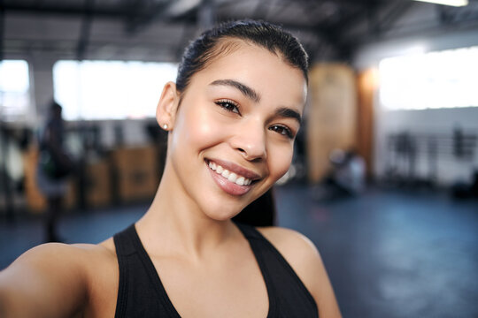 Sweaty selfies are sexy selfies. Portrait of a fit young woman taking selfies at the gym.