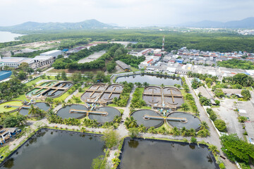 Obraz premium Aerial view High angle view Top down drone shot of the sewage treatment plant.The Solid contact clarifier tank type sludge recirculation in water treatment plant. Industrial wastewater treatment plant