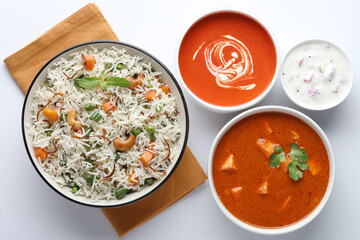 Indian food Vegetable biryani with Paneer butter masala, tomato soup and Curd raita