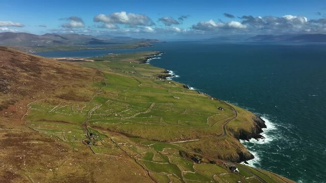 Ventry, Kerry, Ireland, March 2022. Drone in pushes east above ancient rugged farmland at Glanfahan by Dingle Bay along the Wild Atlantic Way with Ballymacdoyle and Dooties in the distance.