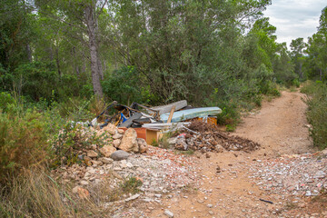 Garbage lying in forest at a rural road in Tarragona, Costa Dorada, Catalonia, Spain