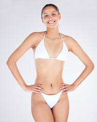 Fototapeta premium Summer ready. Studio portrait of an attractive young woman posing in a bikini against a grey background.