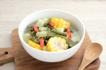 Sayur asam, sayur asem or tamarind soup is a popular traditional Indonesian soup. Common ingredients are chayote, long beans and corn with the addition of tamarind or bilimbi. Served in white bowl.
