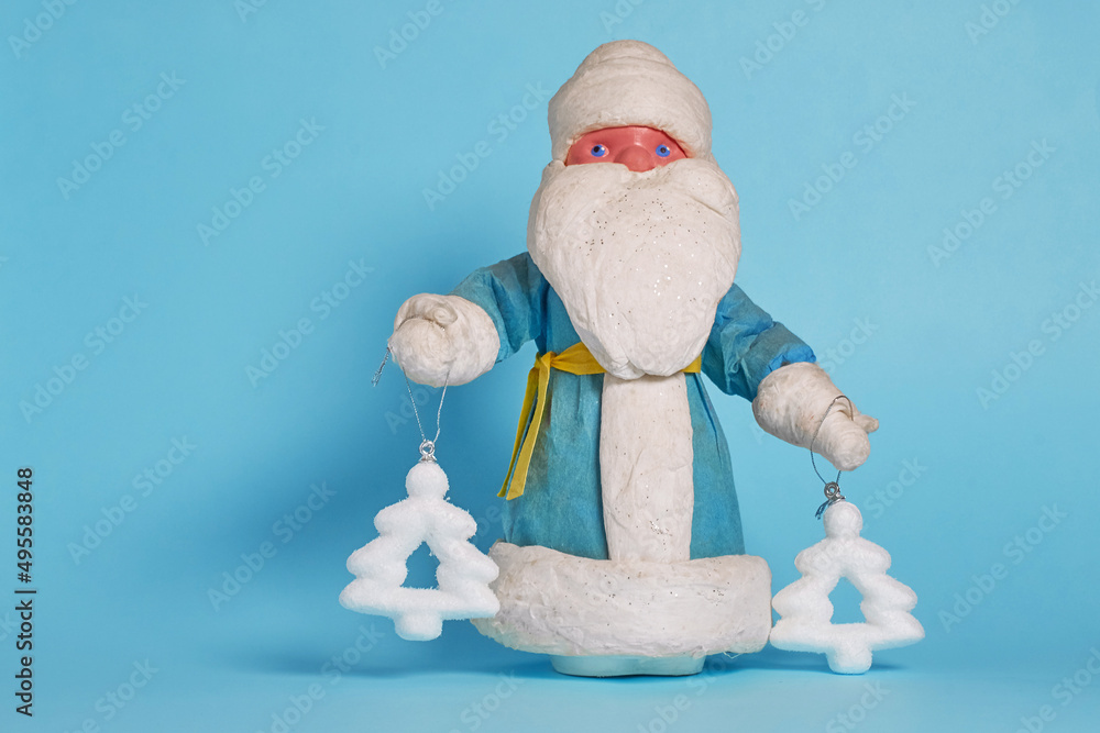 Wall mural Toy Russian Ded Moroz holds Christmas tree toys in his hands