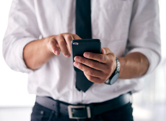 The tools of my success. Shot of a businessman using his smartphone to send a text message.