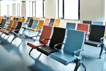 Hospital waiting room with many empty chairs in lines