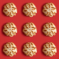 Seamless pattern with coconut macaroons for Jewish holiday Pesach on red background.